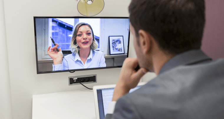 test tun video interview. video interview tips. image of a man and woman doing a video interview on computers.